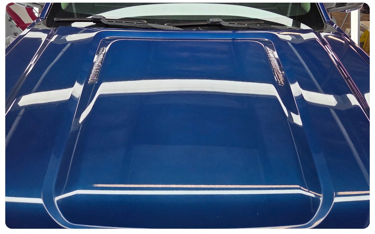 Glossy blue truck hood with a mirror finish after paint correction by Car Passion Solutions