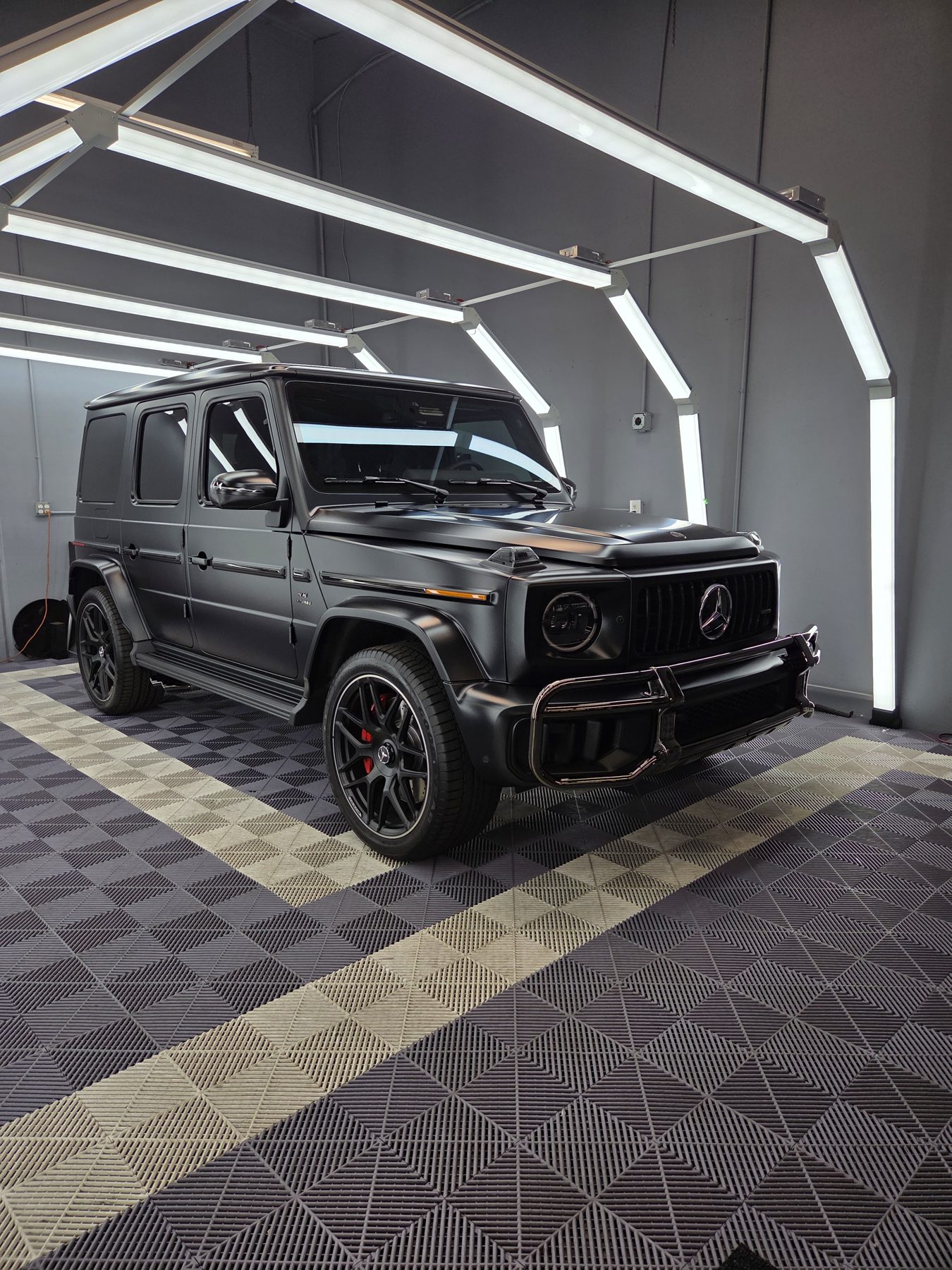 Matte black Mercedes G-Wagon in the Car Passion Solutions light bay in Pomona
